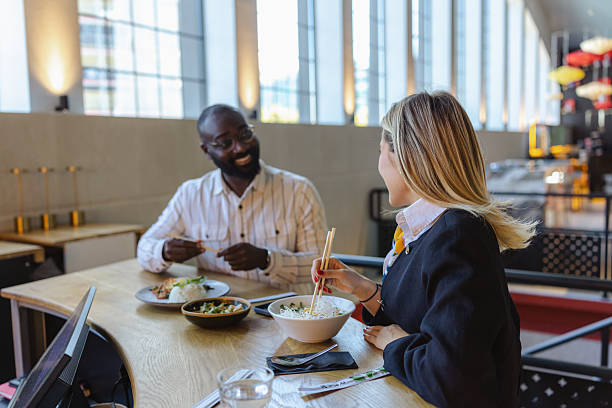 istock Business lunch with coworkers at a modern restaurant, friendly conversation and shared meals 2252343714