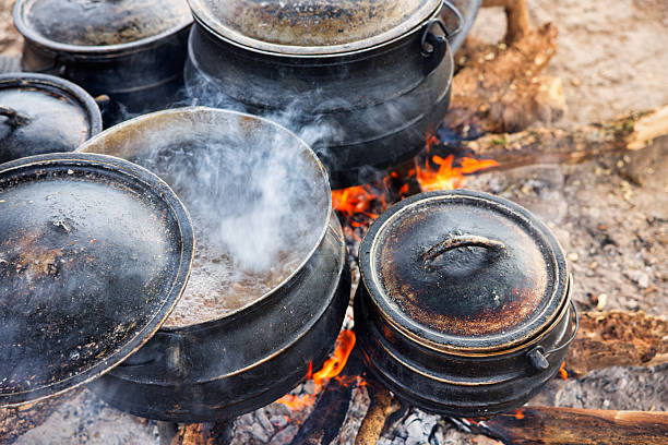 istock cast-iron, three-legged pots, potjies, used for cooking outdoors over an open fire, cooking traditional food in rural areas Botswana 2252343891