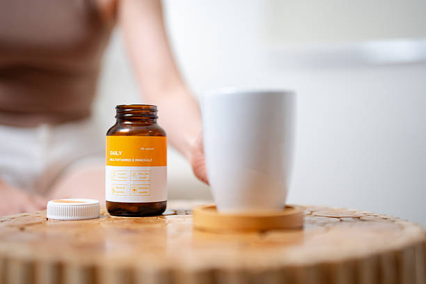 istock Young woman carefully reading the nutritional label on her supplement container 2252344651