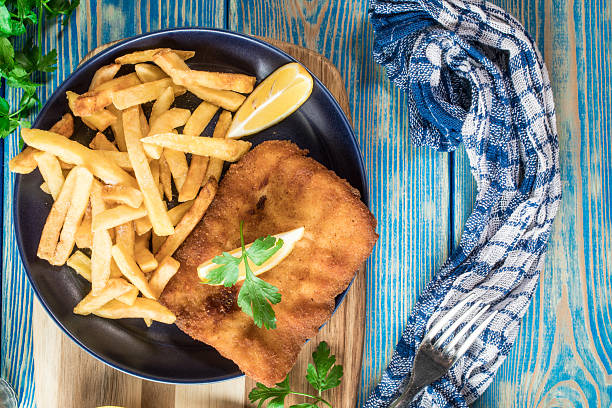 istock A piece of fried cod with fries on a plate. 2252346248