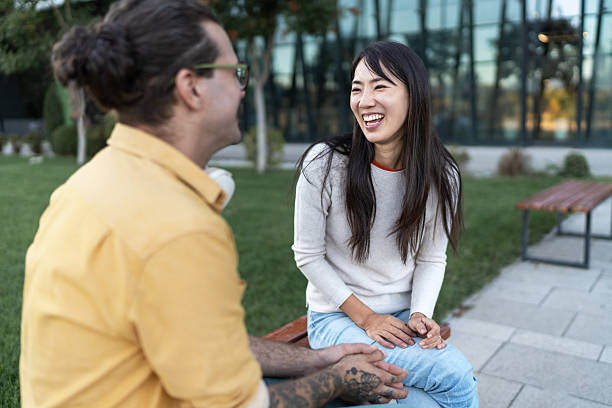 istock Diverse couple laughing enjoying date in park 2252349968