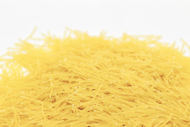 Bundle of raw spaghetti tied with rope on wooden background