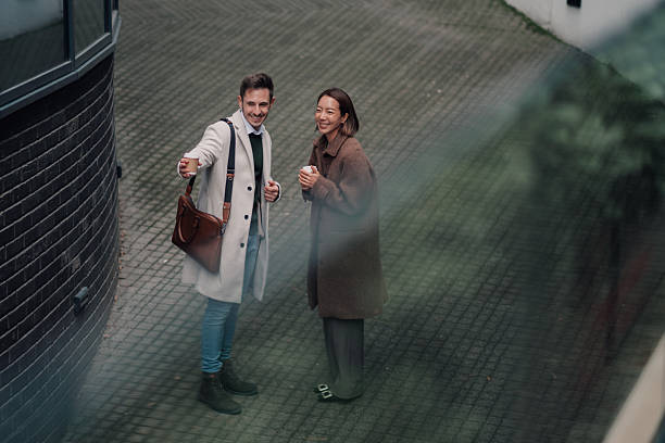 istock Business colleagues having coffee break outdoors and talking 2252352126
