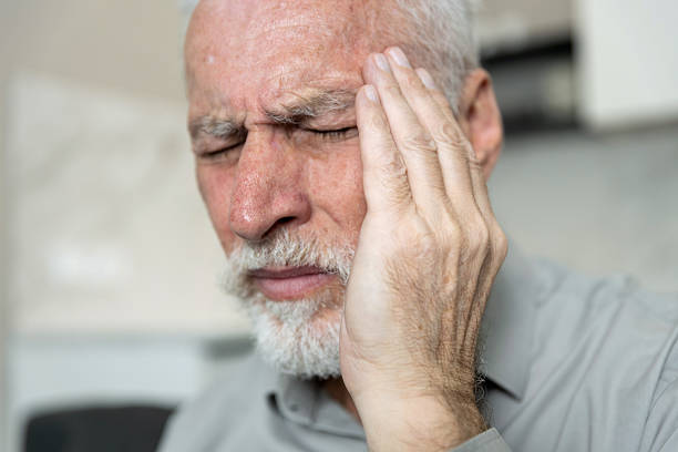 istock Elderly man experiencing headache while sitting in a living room 2252352787