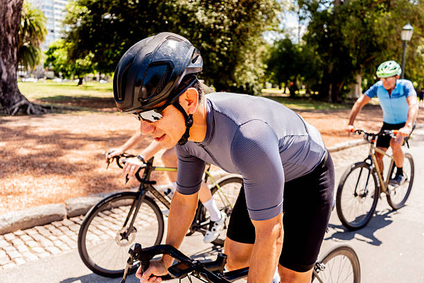 A group of cyclists enjoying a recreational bike ride together on a scenic tree-lined path, demonstrating camaraderie and active lifestyle through outdoor exercise.