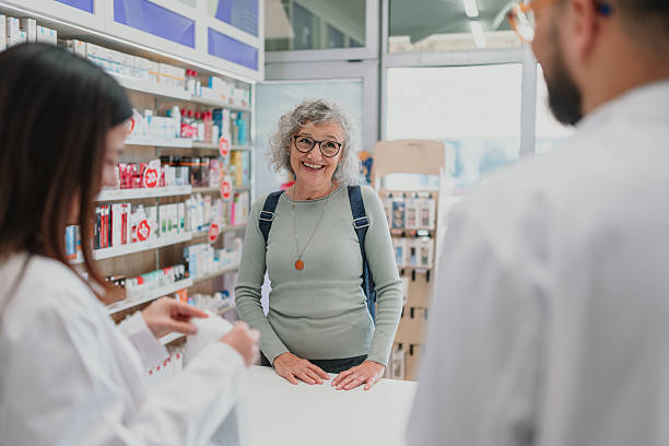 istock Pharmacists serving senior woman customer at counter 2252355918