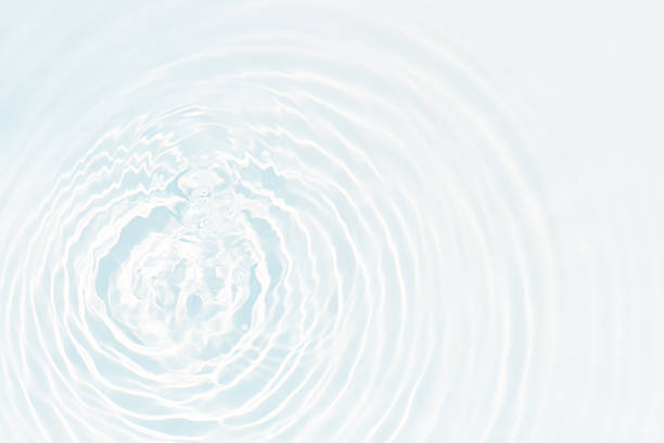 istock Bluewater waves on the surface ripples blurred. Defocus blurred transparent blue colored clear calm water surface texture with splash and bubbles. Water waves with shining pattern texture background. 2252357107