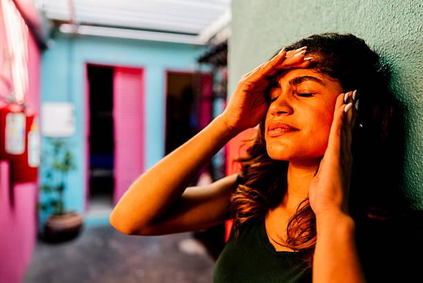 Worried young woman feeling headache