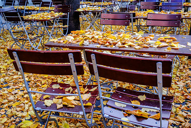 wooden benches and tables at a typical bavarian beergarden - photo