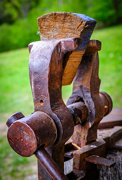 istock Vintage woodworking vise showcased in a rustic workshop setting with tools and cabinets arranged behind it 2252362235