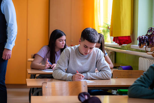 istock Students concentrating on examination in school classroom 2252362377