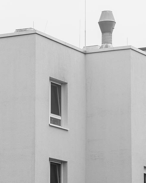 istock Corner view of a modern building with a chimney in a cloudy sky setting 2252363605