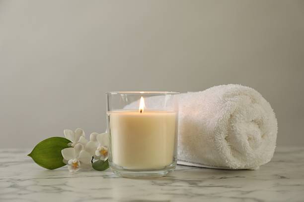istock Beautiful spa composition with burning candle on white marble table, closeup 2252364590