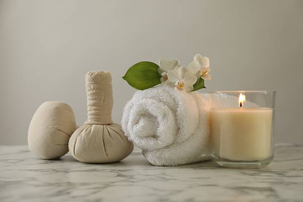 istock Beautiful spa composition with burning candle on white marble table, closeup 2252364595