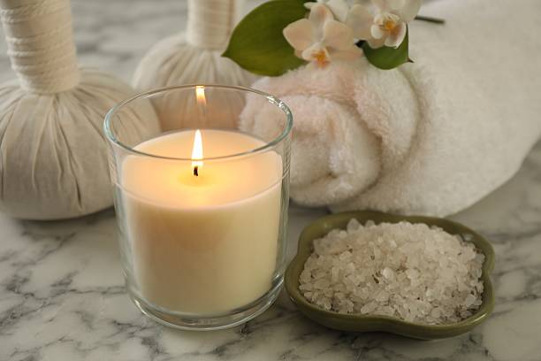 istock Beautiful spa composition with burning candle on white marble table, closeup 2252364701
