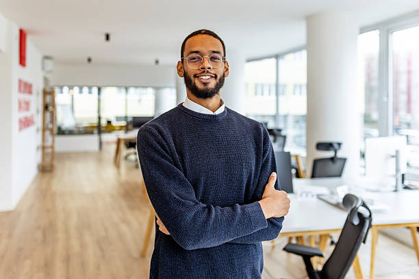 istock Confident Young Professional Man Standing With Arms Crossed in a Bright Modern Office 2252365226