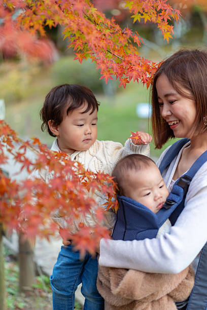 Family enjoying autumn leaves