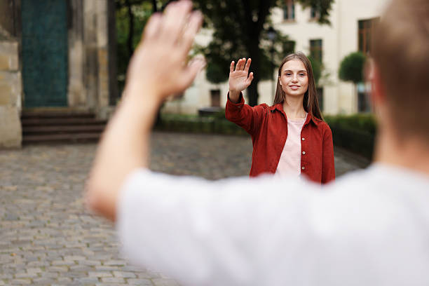 istock Goodbye. Man waving to his girlfriend outdoors, selective focus 2252366979