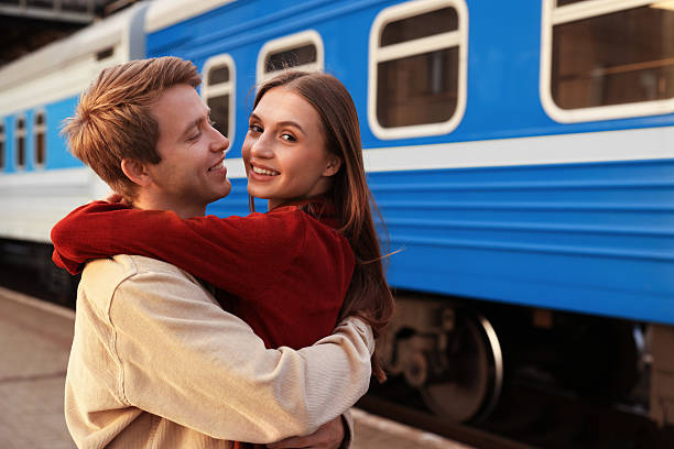 istock Goodbye. Lovely couple hugging near train outdoors, space for text 2252367205
