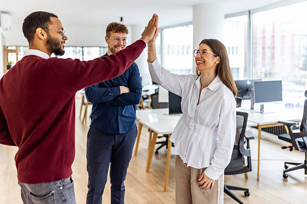 istock Office Team Celebrates Success With High Five Among Friendly Colleagues In Bright Modern Workspace 2252367992