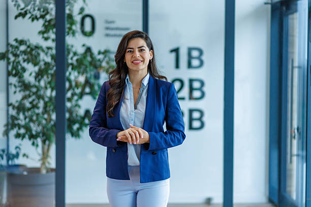 istock Confident businesswoman smiling in modern office environment 2252368391