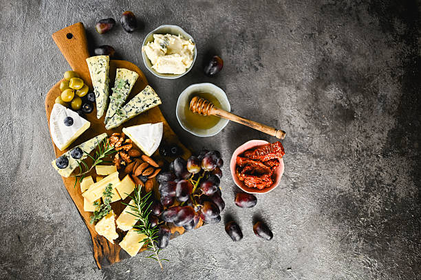 istock Cheese board platter with gourmet cheeses and grapes top view 2252368780