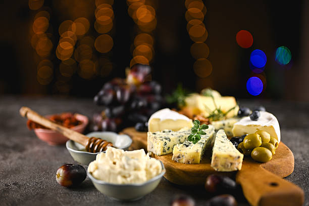 Piece of brie cheese on cutting board isolated on white background