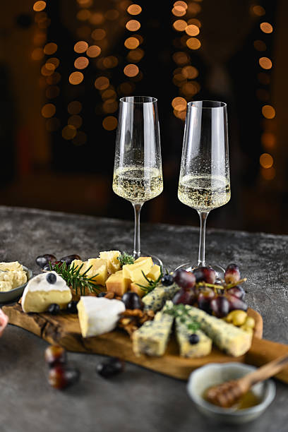 istock Celebrating with champagne flutes and gourmet cheese board 2252368921