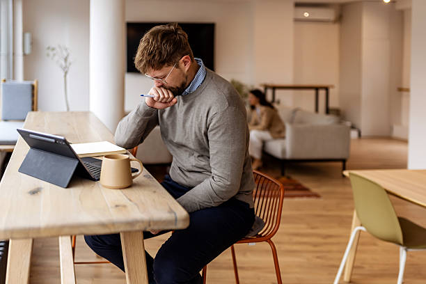 istock Stressed mid adult businessman at work with headache 2252370267