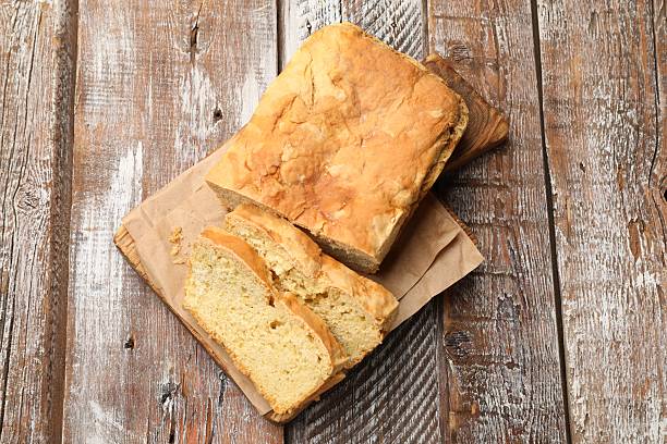 istock Freshly baked cut cornbread on wooden table, top view 2252373228