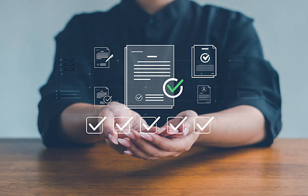 istock business professional holding digital document icons with checkmarks, symbolizing approval, compliance, and workflow efficiency in modern document management and secure data processes. 2252373394