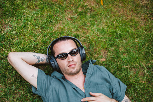 istock Mature Caucasian Non-Binary Person Enjoying Guided Meditation in Sunny Park Setting 2252373615