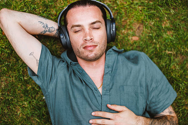 istock Mature Caucasian Non-Binary Person Relaxing in Park Enjoying Guided Meditation 2252373624