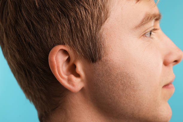istock Sound. Man on light blue background, closeup 2252376169