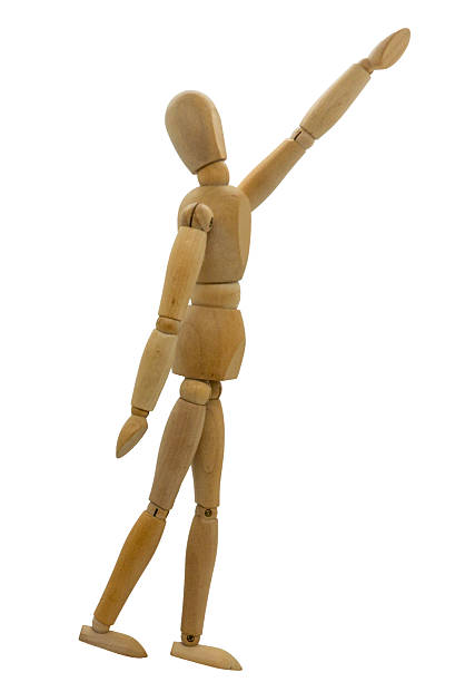istock Wooden jointed figurine posed as if looking up and pointing 2252376386