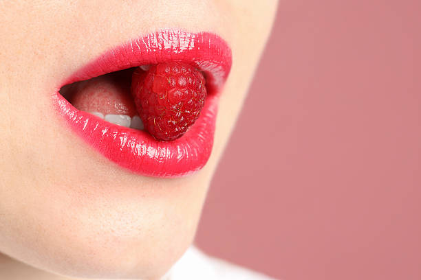 istock Woman with beautiful lips makeup and raspberry on dusty pink background, closeup. Space for text 2252376479