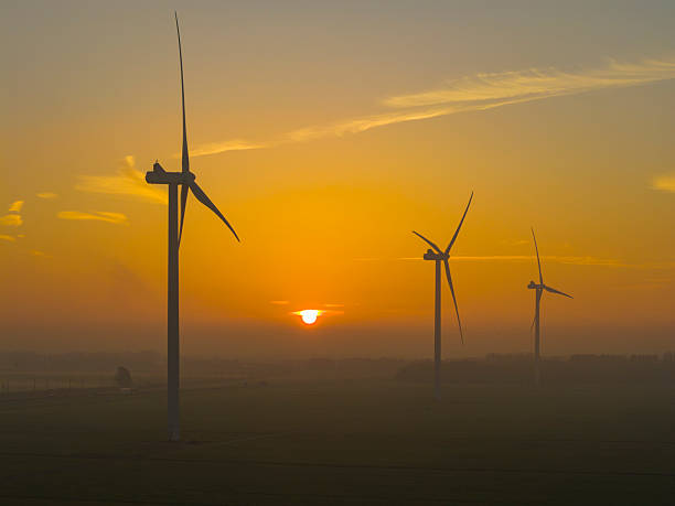 istock Wind turbines producing sustainable energy during sunrise 2252378877