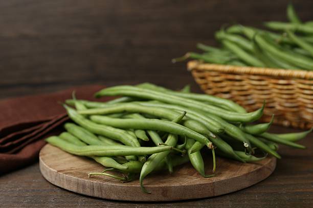 istock Fresh green bean pods on wooden table, closeup 2252379184