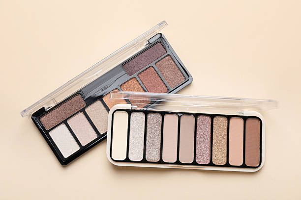 istock Beautiful eyeshadow palettes on beige background, top view 2252381513