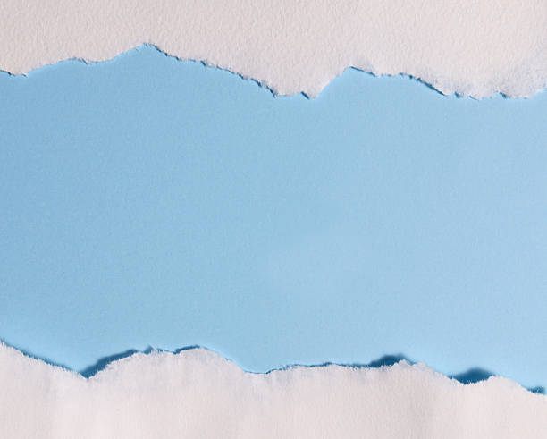 istock Torn white paper creating border on light blue background with empty copy space for design or text 2252381655