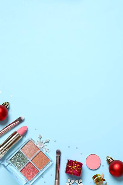 istock Flat lay composition with makeup products and Christmas decor on color background 2252381708