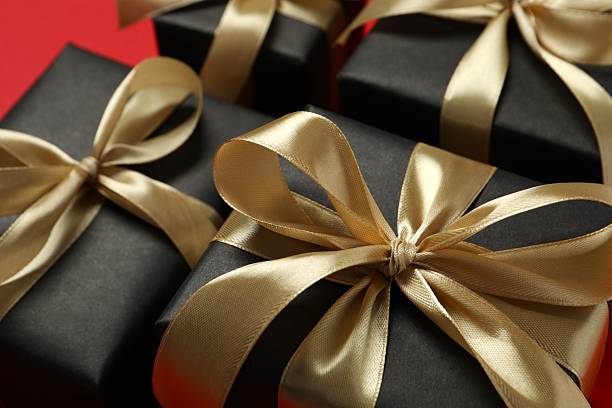 istock Beautiful gift boxes with a golden bows on red background 2252381960