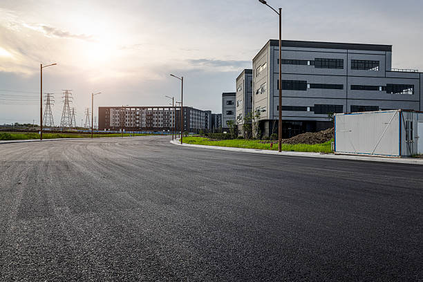 istock Empty asphalt road in a modern industrial park with buildings at sunset. 2252383228