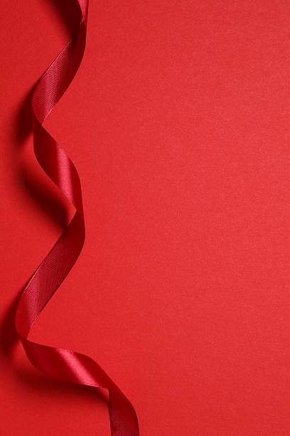 istock Beautiful red silk ribbon on color background 2252383627