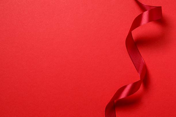 istock Beautiful red silk ribbon on color background 2252383628