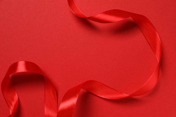 istock Beautiful red silk ribbon on color background 2252383730