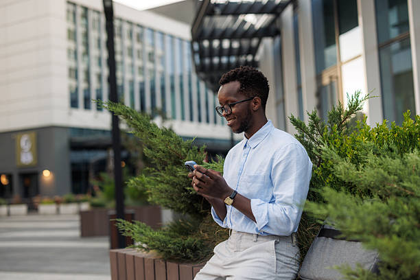 istock Young man using smartphone outdoors in city 2252385535