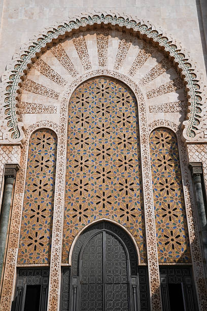 Ben Youssef Madrasa in Marrakesh, Morocco. Elaborate temple made of ornate mosaic tile with beautiful stone arches