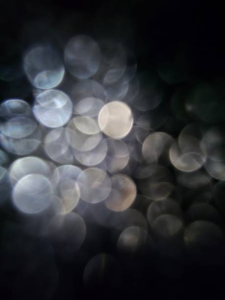 istock Abstract silver and white bokeh lights on dark background 2252386198