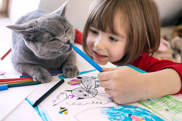 istock Boy and cat in playful drawing moment 2252387499
